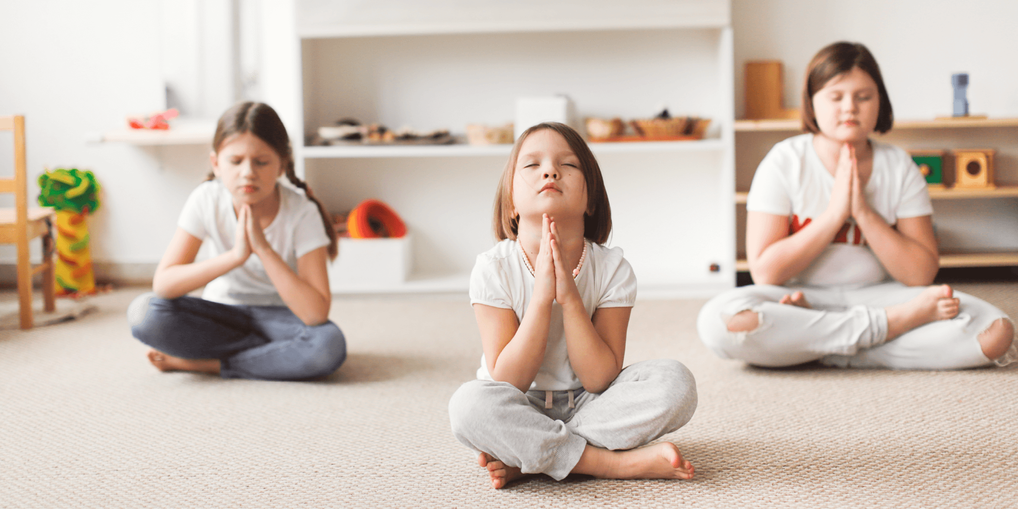 3 girls in a yoga meditation pose